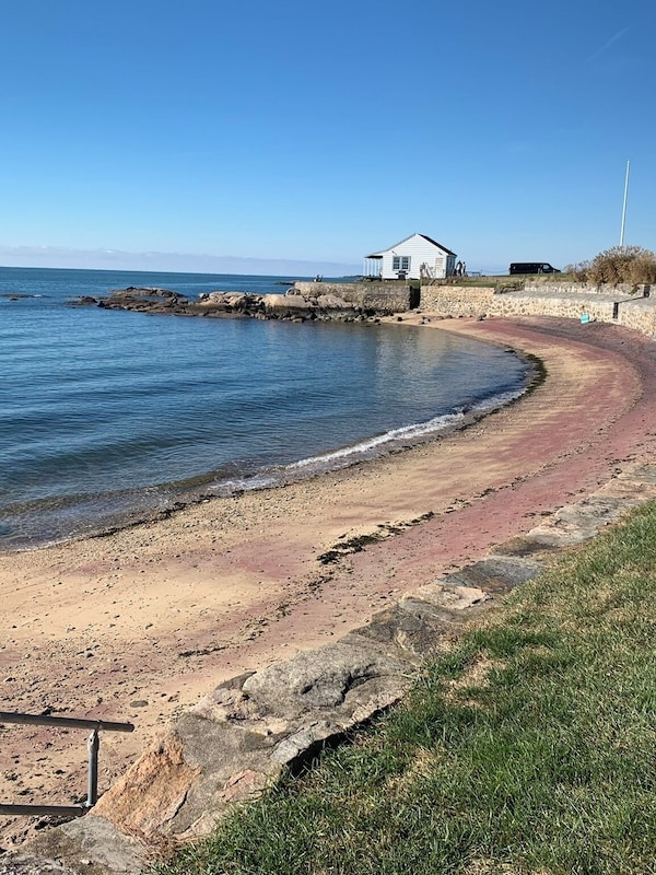 Relax on the beautiful, private neighborhood beach with unique red sand.