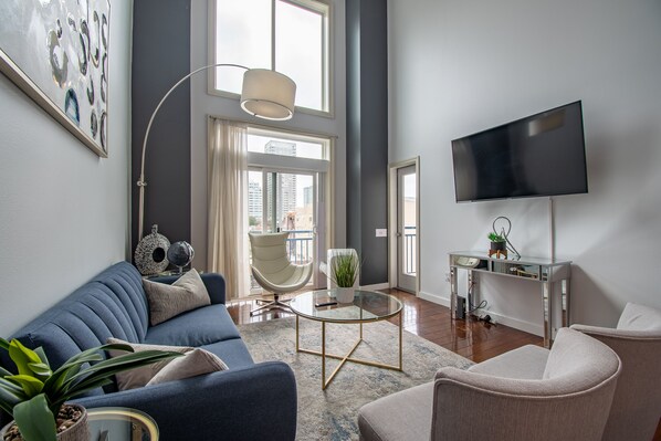 Living Room with a Large TV, Vaulted Ceiling Windows & Sleeper Sofa