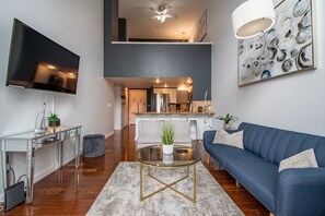 Living Room with a Large TV, Vaulted Ceiling Windows & Sleeper Sofa