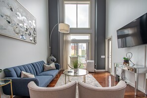 Living Room with a Large TV, Vaulted Ceiling Windows & Sleeper Sofa