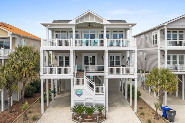Front porch both levels w/cozy seating and carport w/plenty of room for parking
