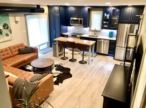 Open floor plan featuring kitchen, dining, and den in one space.