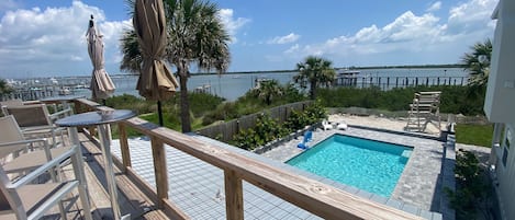 Rooftop deck overlooking the saltwater swimming pool and waterway