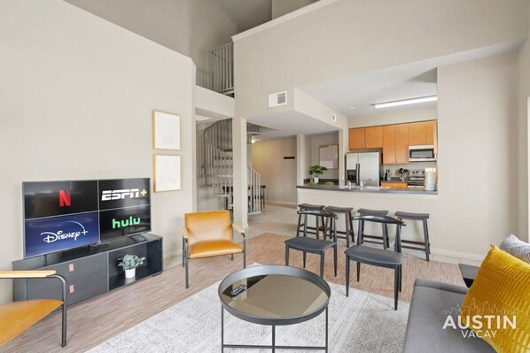 Living room with convertible sofa and large smart TV