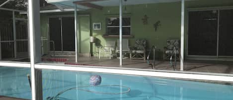 Screened Pool with dining table and full sized refrigerator