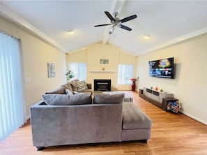 Spacious family room with a 65 inch tv and board games 