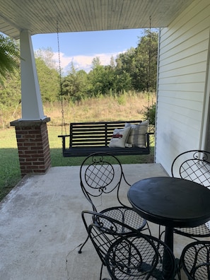 Front porch swing and patio table eating area