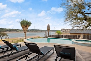 Comfortable lounge chairs on the pool deck overlooking the lake.