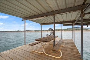 Dock with picnic table, hanging chair & ladder.