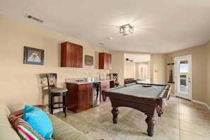 Game room with pool table & wet bar! Right inside from the pool deck.