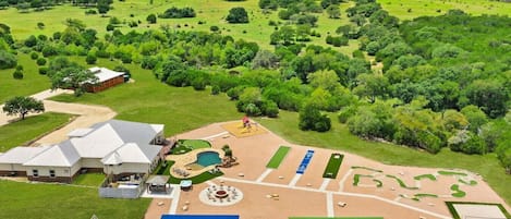 [Resort Property] Aerial view of the property showing basketball court, volleyball, pickleball, mini golf, heated pool, fire pit, and more!