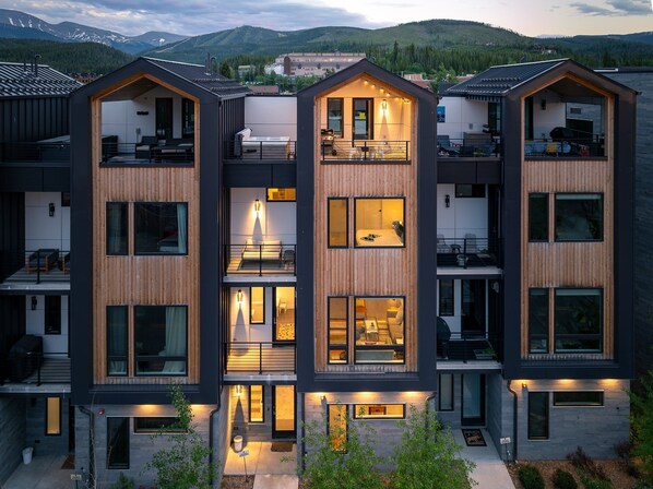Building exterior with rooftop patio and hot tub