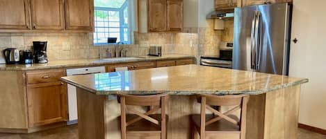 Vast granite countertops provide space for prepping meals or planning excursions