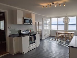 Fully equipped, bright kitchen with wraparound lake views.