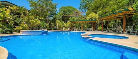 Refresh yourself in paradise! Our sparkling shared pool nestled among lush greenery will serve as a prime hangout spot to cool off during your tropical vacation