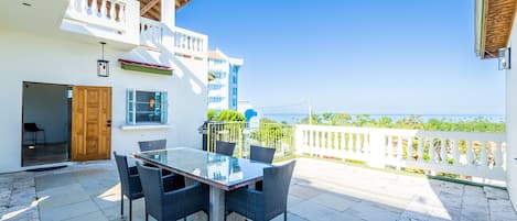 Spacious patio connects the separate rooms and overlooks the Caribbean Sea.