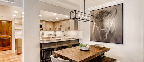 Kitchen opens to the dining room, feature bison wall art