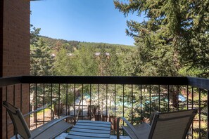 A private balcony has seating for two and views of the mountain.