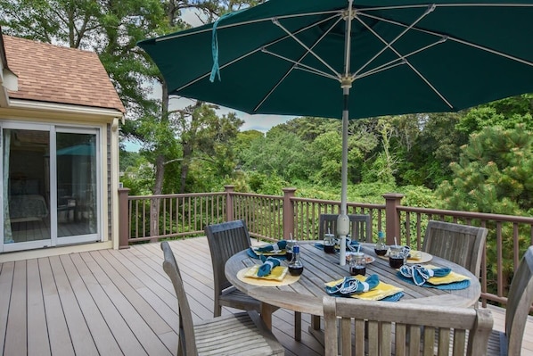 The backyard deck with outdoor dining table set for six.