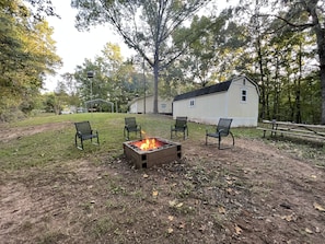 Fire pit with outdoor furniture and picnic table. 