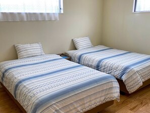 ・ EAST bedroom with 2 semi-double beds. The sofa on the first floor can also be used as a bed.