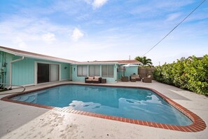Heated pool and shaded outdoor seating, sun loungers and Patio area make this garden easy to enjoy