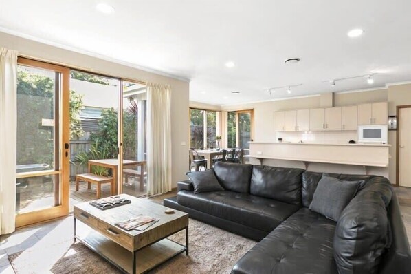 The open plan lounge and dining area is perfect for relaxing after a day at the beach