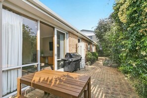 The north-facing courtyard is perfect for outdoor dining, with a BBQ and seating area