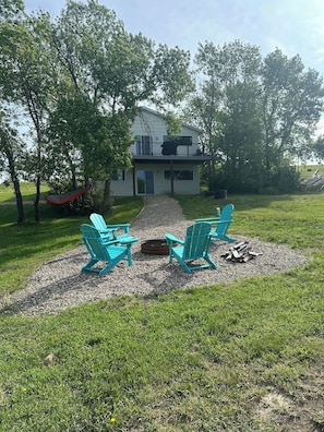 Backyard oasis with fire pit, hammock, and large deck. Yard games stored inside.