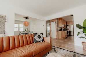 Living room with leather couch and smart tv and open concept