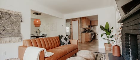 Living room with leather couch and smart tv