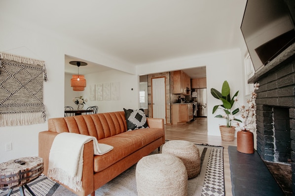 Living room with leather couch and smart tv