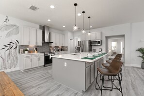 Kitchen with Stainless Appliances, Wine Fridge for Perfectly Chilled Wine.