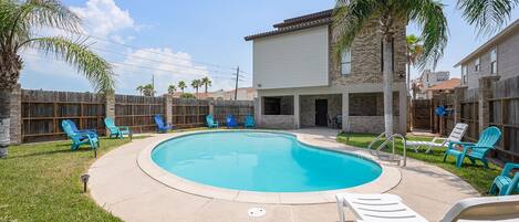 Sparkling swimming pool with ample pool lounge chairs and seating!