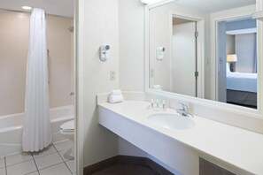 Bathroom with shower and tub. Basic toiletries and towels are provided