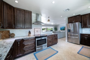 Our kitchen is a Chef's dream! Stainless steel appliances, double door fridge, dark rich wood cabinets and elegant marble counter tops. 2 Seater breakfast nook with views of the front of the house.