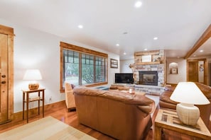 Family room with comfortable sofa seating, flat-screen TV, and an indoor gas fireplace
