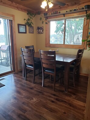 Dining table with 4 chairs and bench along the wall side