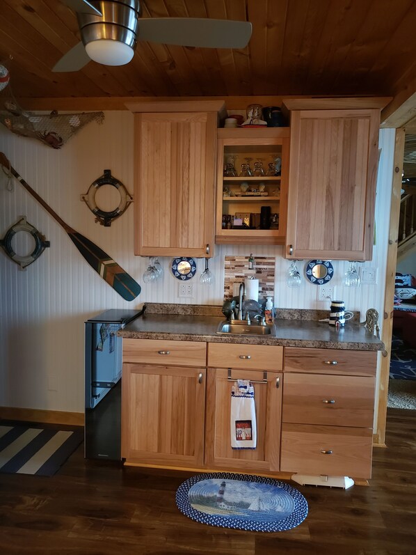 Wet bar in kitchen and wine refrigerator.