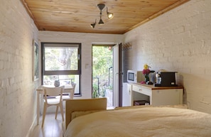 Double-bed looks onto the garden and flag-stone patio.