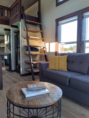 Living room with stairs leading to the loft