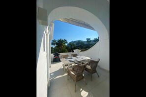 Spacious terrace with natural sun shade in the back of the terrace