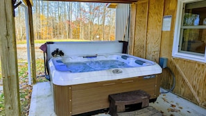 Large hot tub on covered patio.  Enjoy all year long!