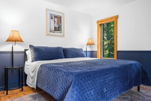 King bed in main level master bedroom with memory foam topper and down alternative pillows. 