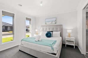 The Master Bedroom includes 1 very comfy King Size Bed, a spacious walk-in wardrobe, and a private ensuite bathroom with a waterfall showerhead.