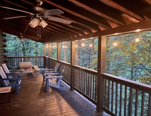 Enjoy nature under the covered back deck with ample seating and comforting fans.
