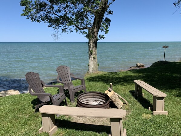 Relax at this lakeside firepit with a view of the Pte. Aux Barques Lighthouse!