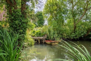 The garden has a small pond with a rowing boat, perfect for relaxing by with a good book