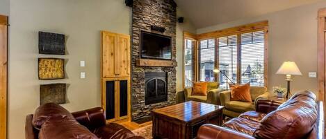 Lovely open concept living space with TV, games, and access to the deck and hot tub.