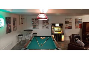 pool table and jukebox in the movie room downstairs